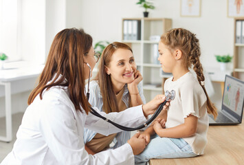 Obraz premium Pediatrician, female pediatrist doctor with stethoscope listening to heart, lungs, child health care in clinic checking up exam, small patient healthcare in hospital for controlling kid developing 