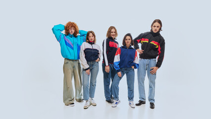 Group of young stylish people wearing retro-style jackets in bold colors, paired with jeans and...