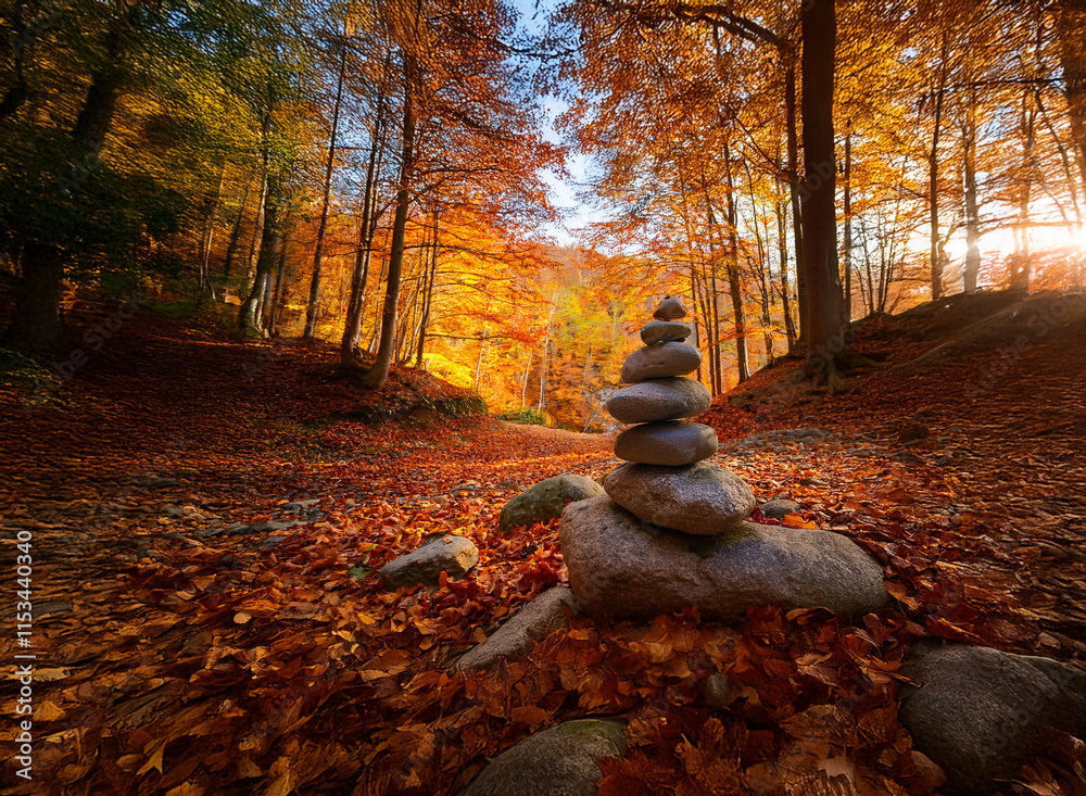 Poster serene autumn forest path with a carefully balanced stone cairn. sunlight filters through vibrant fa