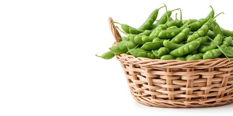 A wicker basket filled with fresh green pea pods on a white background