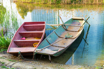 A boat docked on the shore of a lake