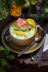 Creamy red fish soup on wooden background