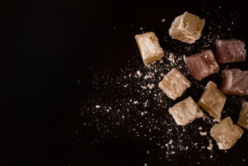 Turkish delight candies on dark surface