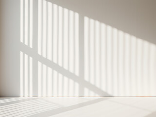 Fototapeta premium White wall with shadows and light from a window creating abstract patterns