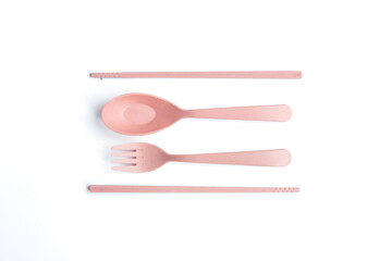 Pink Cutlery and Chopsticks Set on White Background