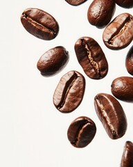 Obraz premium Freshly Roasted Coffee Beans Falling Gently on White Background, Capturing the Rich Texture and Natural Color Variation of Gourmet Coffee