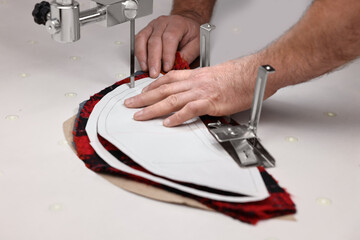 Man working at white table in professional workshop, closeup
