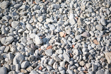 Sea pebbles on the beach, close-up. Pebble background for publication, poster, calendar, post, screensaver, wallpaper, postcard, banner, cover, website. High quality photo