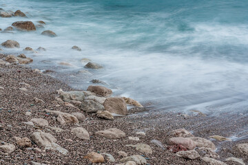 Sand beach with white waves, close-up. Foamy coastline. Seascape for publication, poster, calendar, post, screensaver, wallpaper, postcard, banner, cover, website. High quality photo