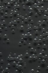 Soda water with bubbles of gas in glass, closeup