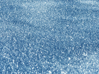 Tiny ice crystals on a fresh white snow cover or a base of tiny snowflakes of alpine snow over the...