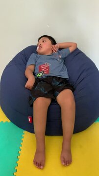 Children who use NGT (nasogastric tube) or sonde are experiencing seizure disorders while sitting on a blue bean-shaped sofa