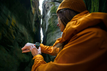 Over the shoulder view of Female Checking Current Altitudeon Casio Wrist Watch While Exploring a...
