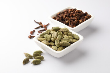 Spices cloves, cardamom  in ceramic bowls ,selective focus