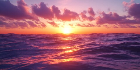 Obraz premium Ocean sunset casting vibrant colors over the horizon, showcasing the beauty of the ocean as the sun sets towards the land, creating a picturesque view of the ocean at dusk.