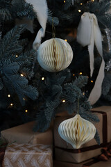 New Year's toys balls made of paper hang on the tree. Christmas.
