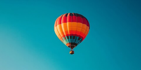 Fototapeta premium Colorful hot air balloon soaring against a vivid deep blue sky, creating a stunning visual contrast that highlights the beauty of a colorful hot air balloon in flight.