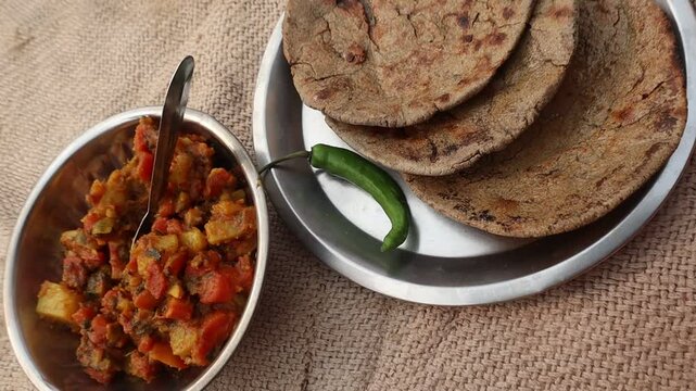 Indian traditional winter food bajre ki roti with green chilli and tomato carrot vegetable