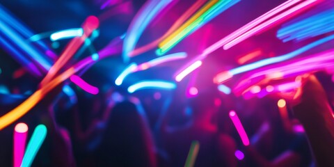 Vibrant neon streaks of light from glow sticks illuminate the atmosphere at a night celebration and rave, creating an exhilarating ambiance filled with color and excitement.