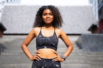 Young African woman is exercising in the city.