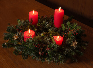 Adventskranz mit vier brennenden Kerzen, Schweiz