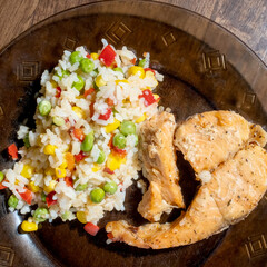 rice, vegetables and fish on dark plate