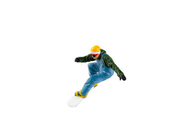 Miniature figurine depicting a snowboarder in mid-motion isolate on white background with clipping...