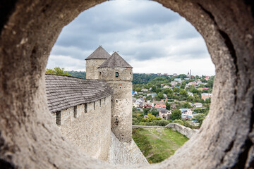 A view of a city from a castle with a round window