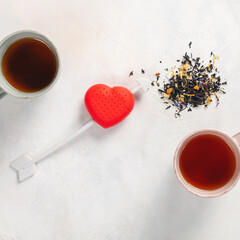 Dry herbal tea on the table. Tea strainer. Valentines day concept. Top view