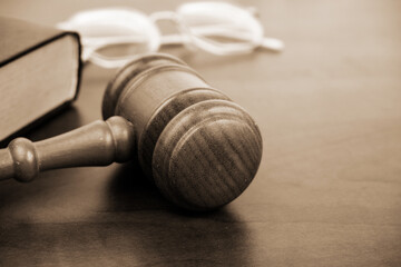 Wooden gavel, legal book and round eyeglasses. Copy space for text.