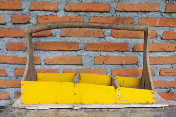 Wooden Construction Basket with Brick Wall Background