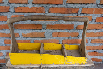 Wooden Construction Basket with Brick Wall Background
