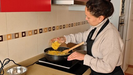 Woman Cooking a Healthy Dish with Corn in the Kitchen