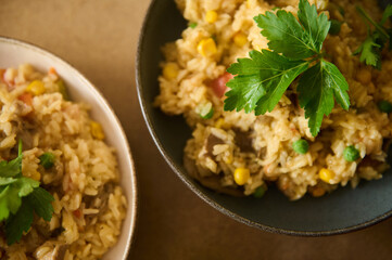 Close-up of vegetarian paella garnished with fresh herbs in two serving bowls