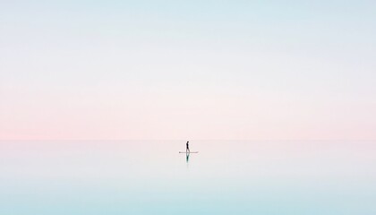 Naklejka premium Serene Paddleboarding Adventure on a Calm and Tranquil Body of Water at Sunrise with Soft Pastel Colors in the Sky