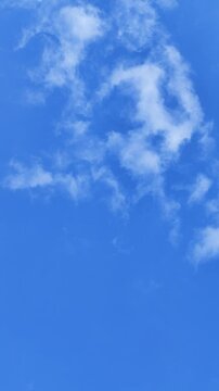 clear blue sky with thin clouds floating vertical 4k footage
