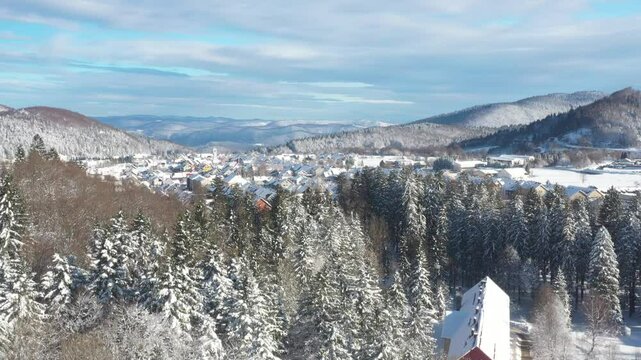 Drone aerial view of the town of Delnice in Gorski kotar in winter under snow, Croatia