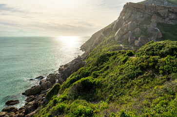 Majestic golden light during golden hour with A rocky coastline of the peninsuala at Robberg nature reserve along the Garden route, Plettenberg Bay, Western Cape province, South Africa, Africa
