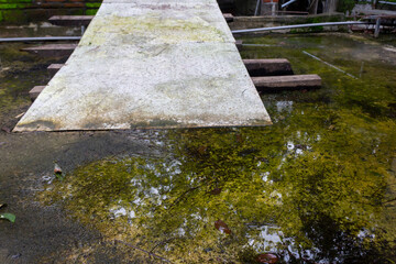 Puddle of Water on Rough Textured Concrete Floor