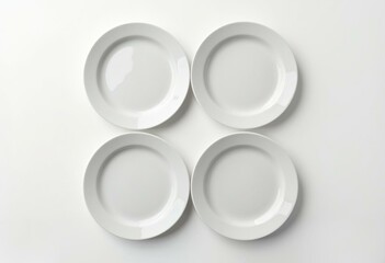 Minimalist grid of four identical white plates on white background
