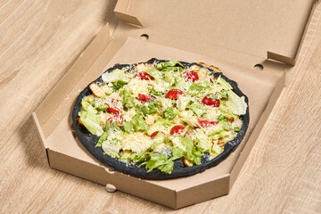 Black Dough Pizza with Chicken and Greens