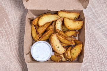 Baked Potato Wedges with Sauce in a Takeaway Box