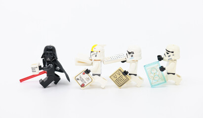Naklejka premium Hong Kong - December 24 2024: death Vader hold the world best boss cup and chasing by stormtrooper