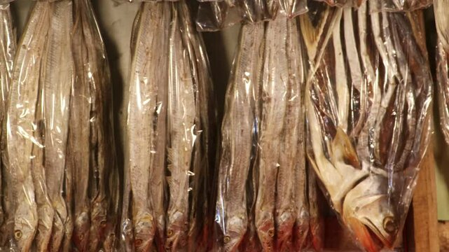 Selling dried salted churi fish in local Asian markets. Varieties of dry fish are sold in the market.