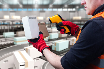 Man warehouse contractor. Laser barcode scanner. Worker near warehouse conveyor. Production line...