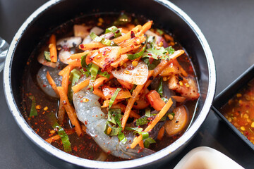Thai style spicy salad with pickled shrimp in fermented fish sauce.