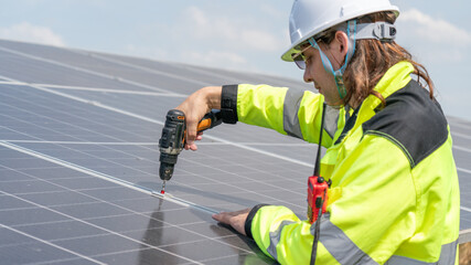 Caucasian electrician, technician, or engineer employed at a solar farm or sungrid plant that promotes clean, renewable energy,sustainable energy concept.