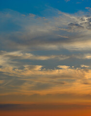 Real majestic sunrise sundown sky background with gentle colorful clouds without birds.