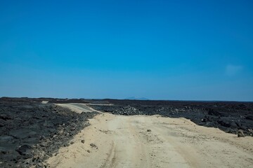 Road through the remote volcanic landscape of the Afar region in Ethiopia