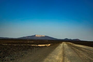 Road through the remote volcanic landscape of the Afar region in Ethiopia